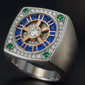 Redbutan high-jewel signet ring featuring a round-brilliant center diamond, sapphire-blue baguette halo and pavé diamonds on a two-tone square head with green accents
