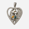 Winged wolf heart pendant with pavé diamond frame, amber and teal gemstones.