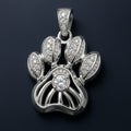 Redbutan Openwork paw-print pendant in white-gold tone with central round diamond.